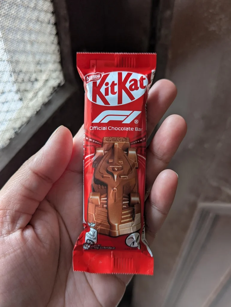 A hand holding the F1 KitKat chocolate