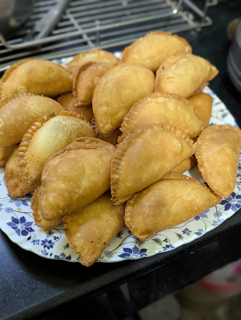 Gujiya stacked on a plate